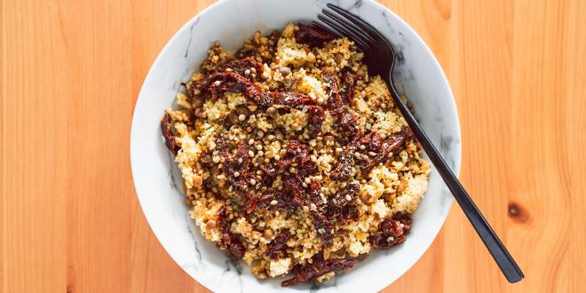 a bowl of couscous with lentils and veggies