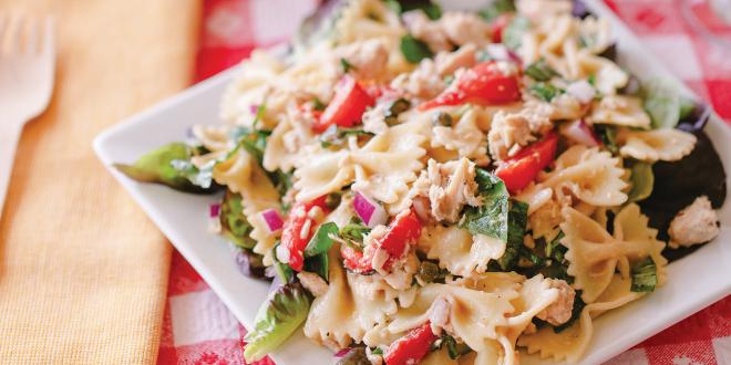 a plate of pasta with tuna and vegetables